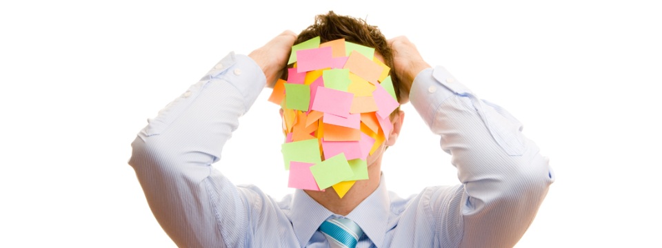 Businessman covered with memos on white background